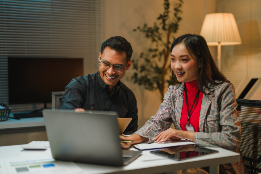 Two professionals reviewing goals on a laptop, building a clear career map for future success.